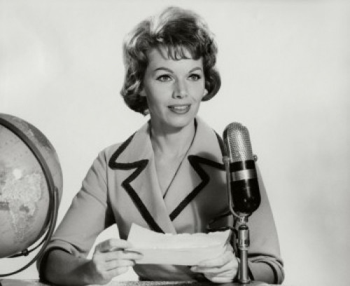 Mid adult woman reading a report into a microphone Poster Print - Item # VARSAL2553068