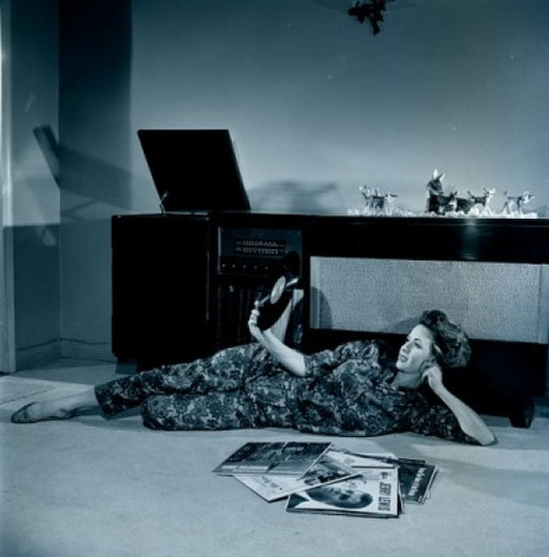 Young woman lying on floor  holding record Poster Print - Item # VARSAL255417194 Young woman lying on floor  holding record Poster Print - Item # VARSAL255417194