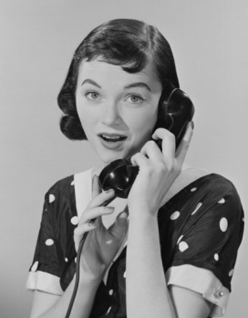 Studio portrait of young woman talking on phone Poster Print - Item # VARSAL255422823