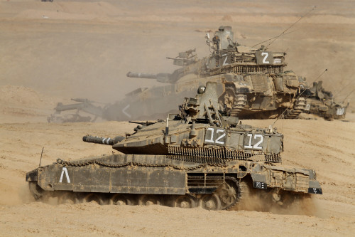 A pair of Israel Defense Force Merkava Mark IV main battle tanks during an exercise in the Negev desert. Attached to the upper tank is a mine clearing device Poster Print - Item # VARPSTZDN100116M