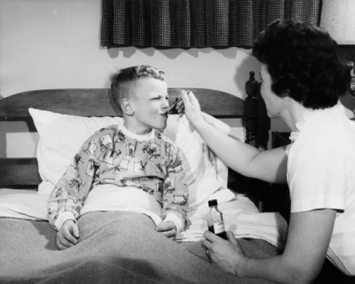 Side profile of a female pediatrician giving medicine to a boy Poster Print - Item # VARSAL2556598