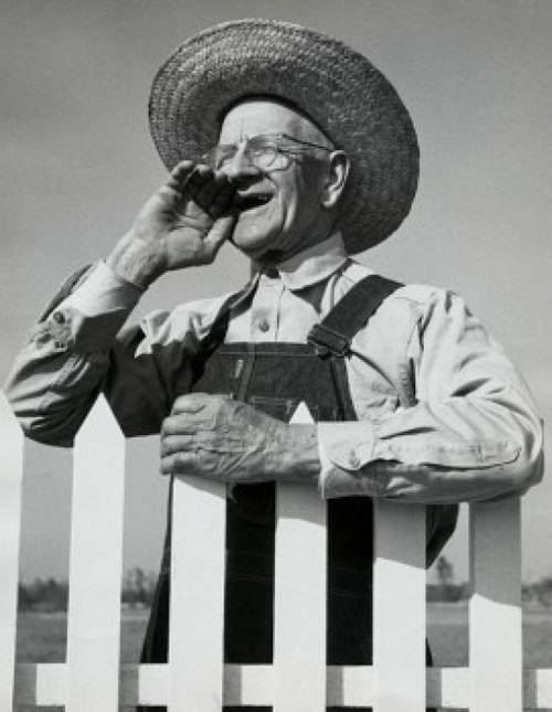 Close-up of a senior man standing near a picket fence Poster Print