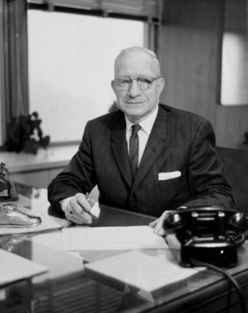 Businessman sitting at a desk in an office Poster Print - Item # VARSAL25548375