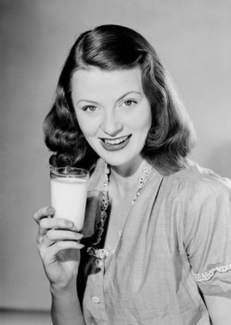 Young woman holding glass of milk Poster Print - Item # VARSAL255422940