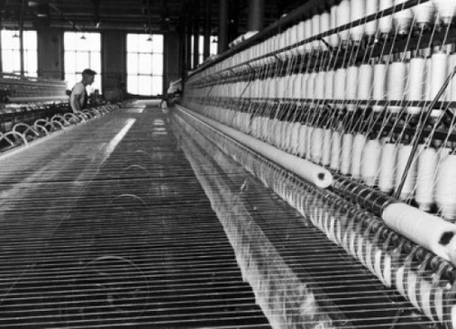 Worker working on a mule spinning machine in a textile factory Poster Print - Item # VARSAL25538343
