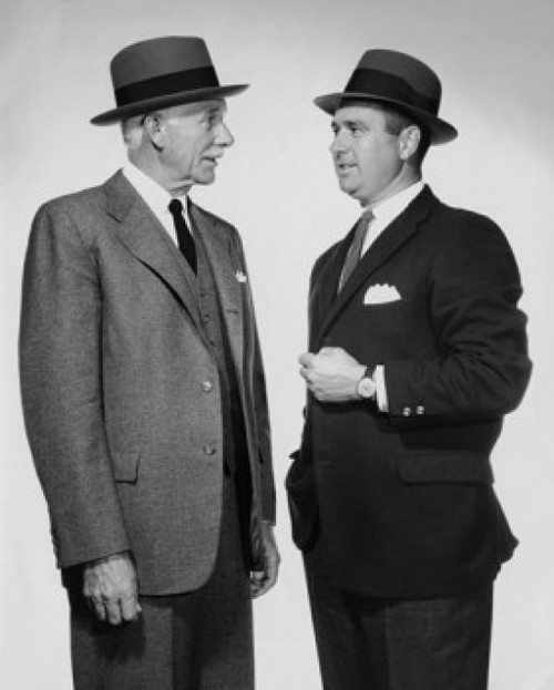 Two mature businessmen talking Poster Print