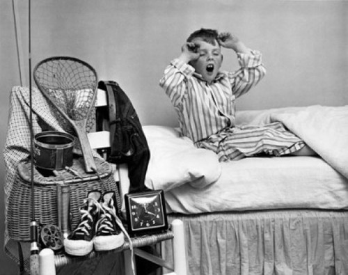 Boy yawning on bed Poster Print