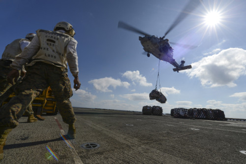 South China Sea, February 8, 2013 - An MH-60S Sea Hawk helicopter lowers pallets of supplies during a vertical replenishment on the flight deck aboard the amphibious assault ship USS Bonhomme Richard Poster Print - Item # VARPSTSTK106790M