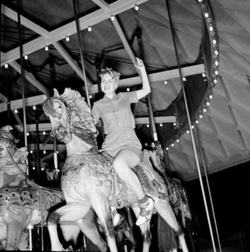 Low angle view of woman riding carousel Poster Print - Item # VARSAL255417475