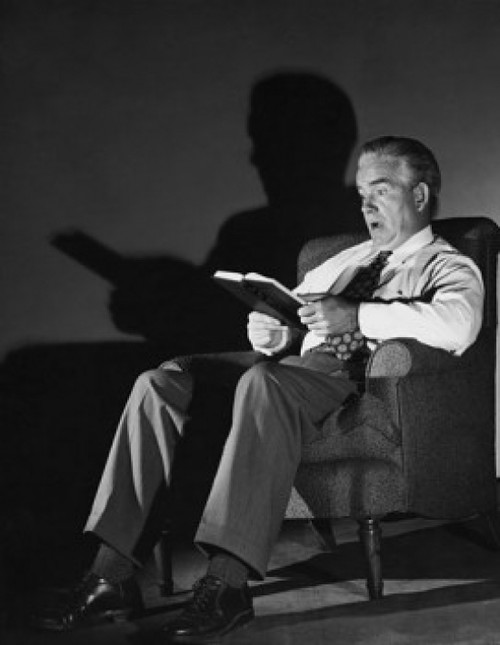 Senior man reading a book Poster Print