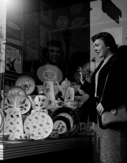 Young woman watching china at window display Poster Print - Item # VARSAL255422151