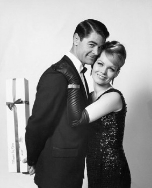 Young woman embracing a young man holding a gift behind his back Poster Print - Item # VARSAL2555807