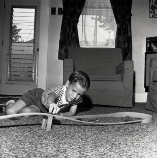 Boy playing with toy car on floor Poster Print - Item # VARSAL255420937