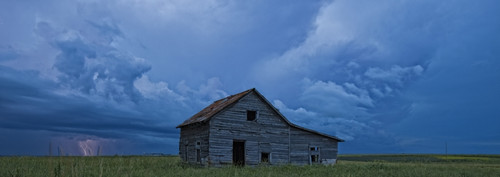 Lightning strikes over the prairies as it approaches an old abandoned farm house; Val Marie, Saskatchewan, Canada PosterPrint - Item # VARDPI2324412