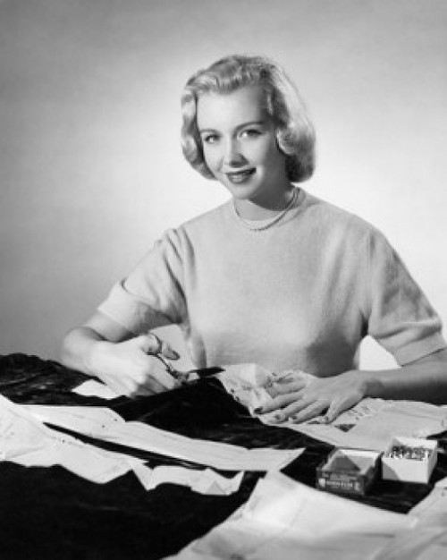 Studio shot of young woman cutting cloth with scissors Poster Print - Item # VARSAL25542072