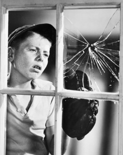 Boy looking at a broken window pane Poster Print - Item # VARSAL25512929