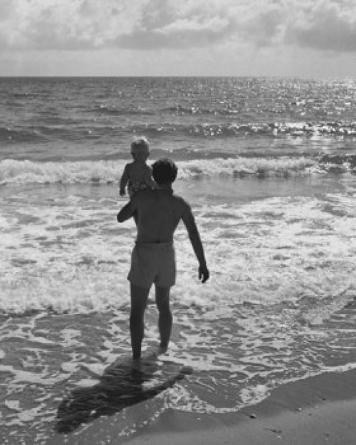 Rear view of a father carrying his son on the beach Poster Print - Item # VARSAL25519680