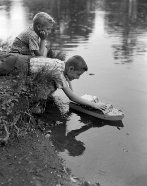 Boys playing with model boat Poster Print - Item # VARSAL25516732