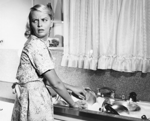 Young woman washing dishes in kitchen Poster Print - Item # VARSAL25541818