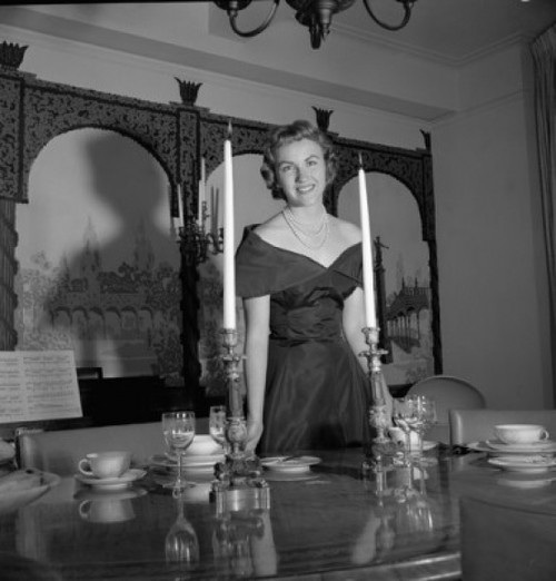 Portrait of a young woman standing near a dining table Poster Print - Item # VARSAL25541910 Portrait of a young woman standing near a dining table Poster Print - Item # VARSAL25541910