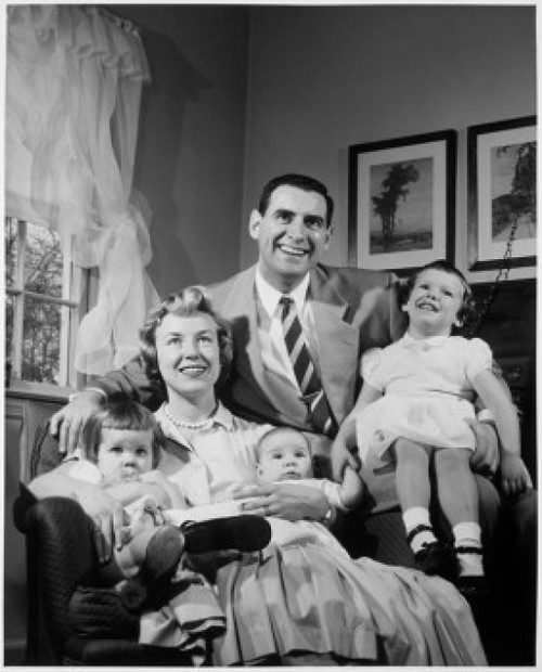 Portrait of parents with three children sitting in living room Poster Print - Item # VARSAL25518628
