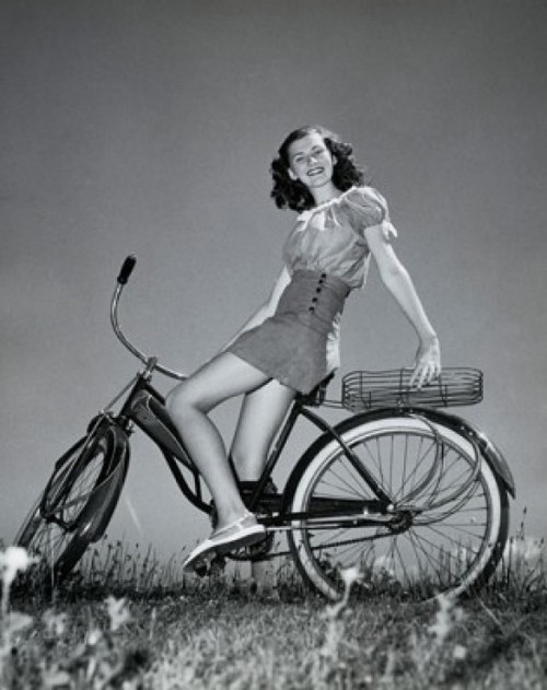 Teenage girl sitting on a bicycle and smiling Poster Print - Item # VARSAL25517495