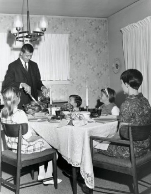 Mature couple sitting at a dining table with their children on Thanksgiving Day Poster Print - Item # VARSAL25539900