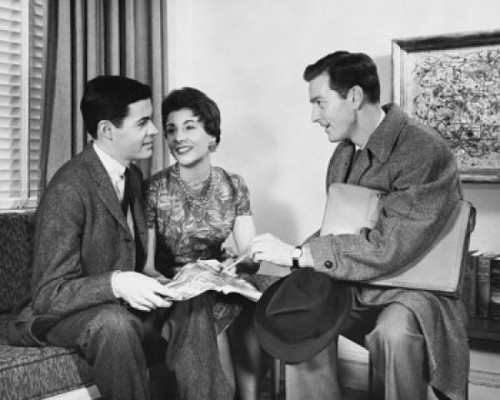 Side profile of a salesman talking to a young couple Poster Print - Item # VARSAL25518742