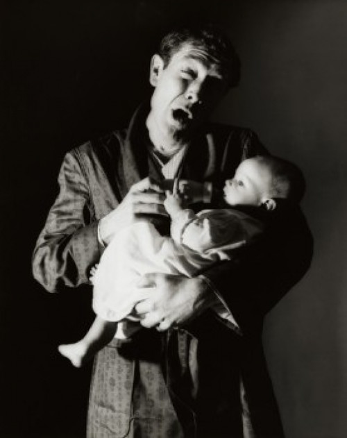 Father feeding his son with a bottle Poster Print