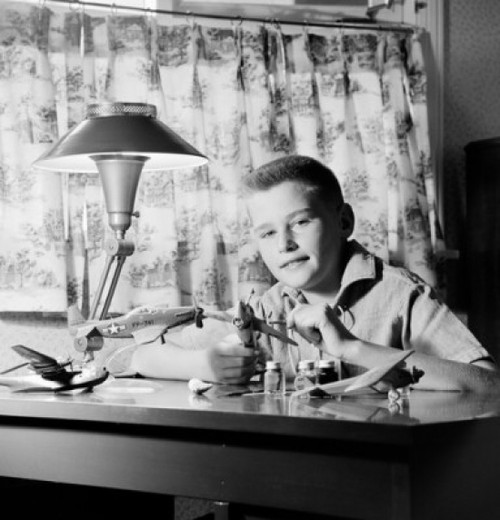 Boy sitting at desk and making model plane Poster Print - Item # VARSAL255418603B