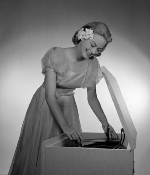 Woman putting record in gramophone Poster Print - Item # VARSAL255416794