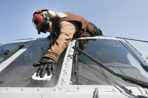 Gulf of Oman, October 19, 2013 - U.S. Navy Airman cleans the windshield of an MH-60R Seahawk helicopter on the flight deck of the aircraft carrier USS Harry S. Truman Poster Print - Item # VARPSTSTK108446M