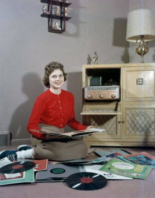 Young woman sitting on floor and choosing vinyl records Poster Print - Item # VARSAL255422646 Young woman sitting on floor and choosing vinyl records Poster Print - Item # VARSAL255422646