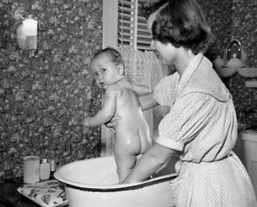 Young woman washing her baby in a washtub Poster Print - Item # VARSAL2559883