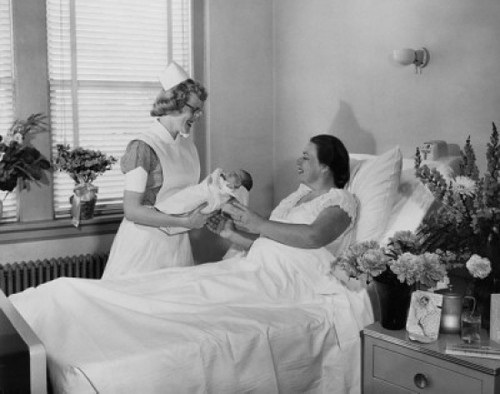 Female nurse giving a newborn baby to a young woman lying in a hospital bed Poster Print - Item # VARSAL2557966