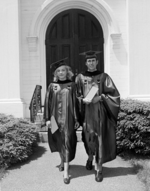 Female and male students wearing graduation gown holding diploma Poster Print - Item # VARSAL255416298