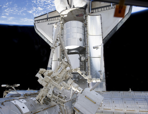 Space shuttle Discovery and the Canadian-built Dextre docked to the International Space Station Poster Print - Item # VARPSTSTK204649S