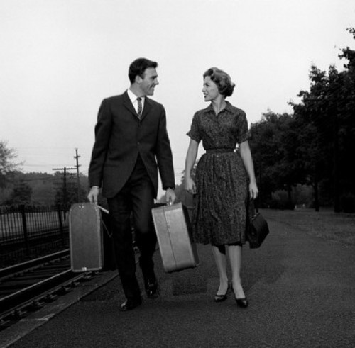 Young couple carrying suitcases at rail station Poster Print - Item # VARSAL255416576A