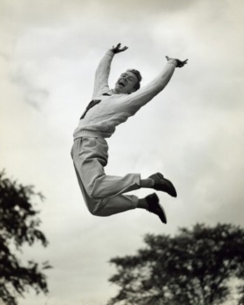 Low angle view of a male cheerleader jumping and cheering Poster Print - Item # VARSAL2553670