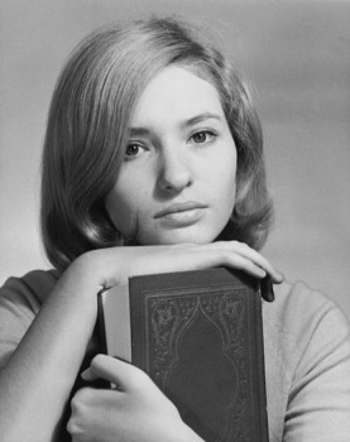 Portrait of a teenage girl holding a book and looking serious Poster Print - Item # VARSAL25517542