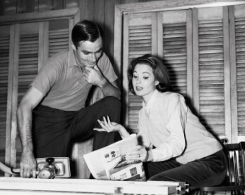 Mid adult woman holding a magazine and talking to a mid adult man Poster Print - Item # VARSAL25529325 Mid adult woman holding a magazine and talking to a mid adult man Poster Print - Item # VARSAL25529325