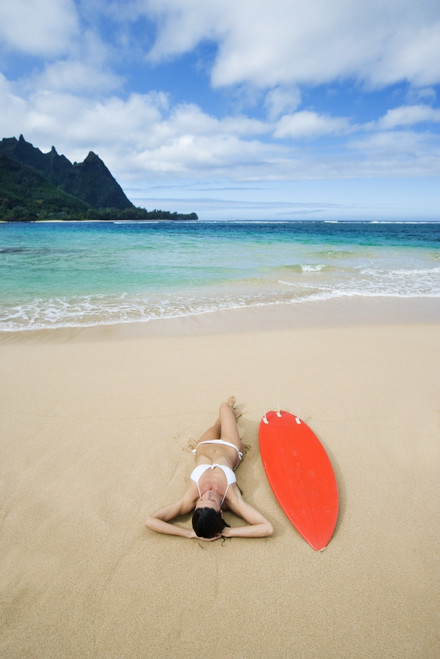 Hawaii, Kauai, Haena Beach Tunnels Beach, Woman Laying On Beach With Surfboard. PosterPrint - Item # VARDPI1966501