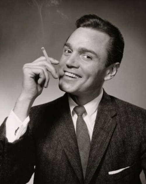 Portrait of a mid adult man smoking a cigarette Poster Print - Item # VARSAL2553028