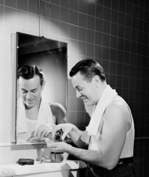 Mature man applying aftershave bathroom Poster Print - Item # VARSAL255424248