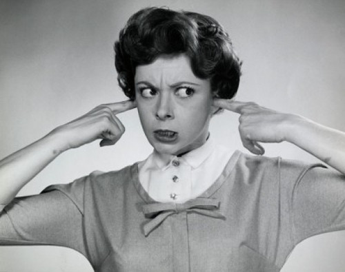 Portrait of young woman with her fingers in her ears Poster Print - Item # VARSAL2551102