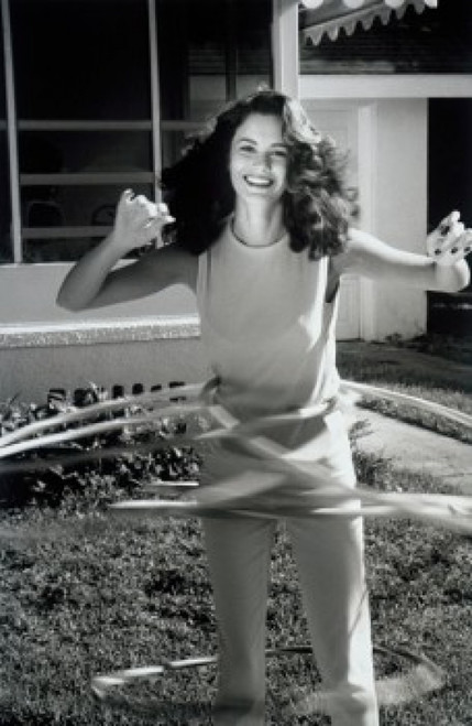 Portrait of young woman playing with hula hoops Poster Print - Item # VARSAL1073102