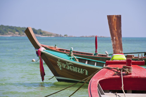 Thailand, Phuket, Rawaii Beach, Close up of longtail boats along the shoreline, Land in distance. PosterPrint - Item # VARDPI2116494