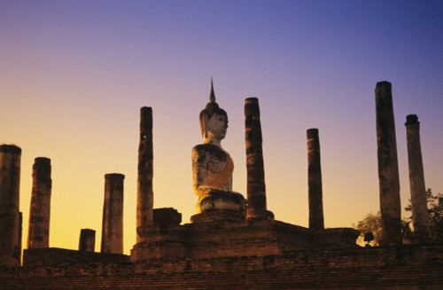 Thailand, Sukhothai, Wat Mahathat, Buddha Statue With Many Pillars At Sunset, Blue And Orange Sky. PosterPrint - Item # VARDPI1987113