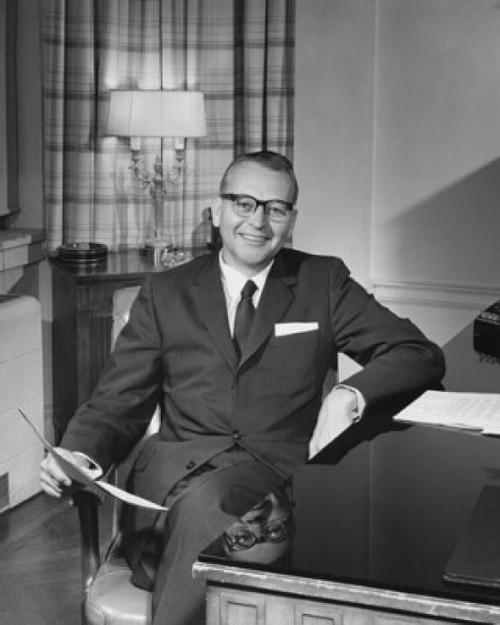 Businessman sitting in a chair and holding a document Poster Print