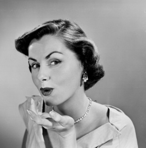 Studio portrait of young woman blowing kiss Poster Print - Item # VARSAL255417490